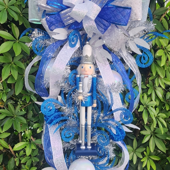 Blue White and Silver Christmas Swag with a Nutcracker and White Ornaments.